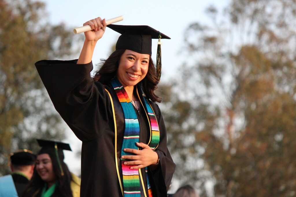 A woman holding her diploma