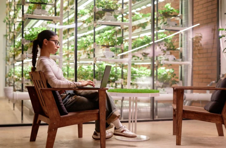 Seorang pekerja Gen Z bekerja santai di kafe dengan konsep work life balance